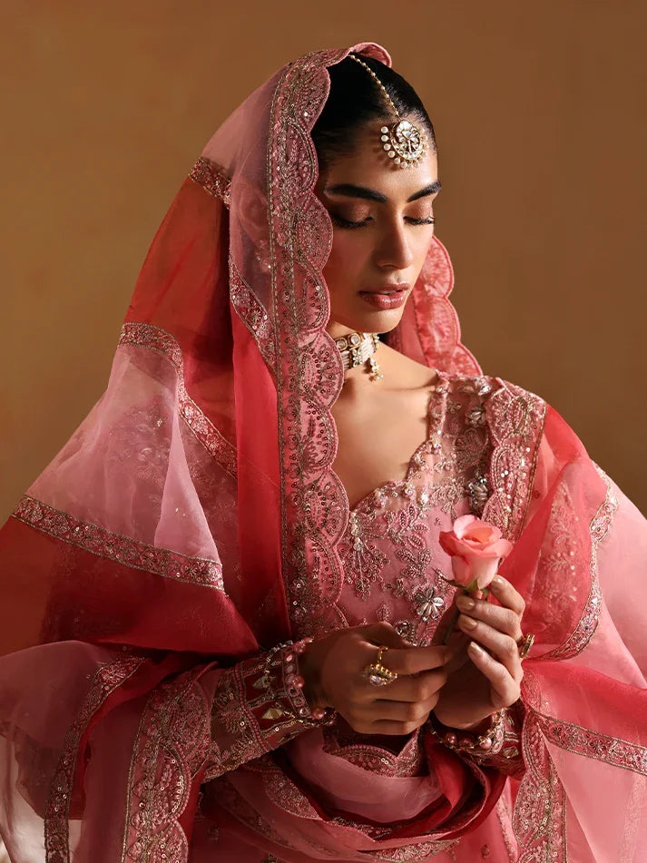 "Focus on the intricate panni-embroidered sleeve border trimmings and lace hemline details of the Gulaal Areeman stitched luxury suit, showing boutique-quality tailoring."