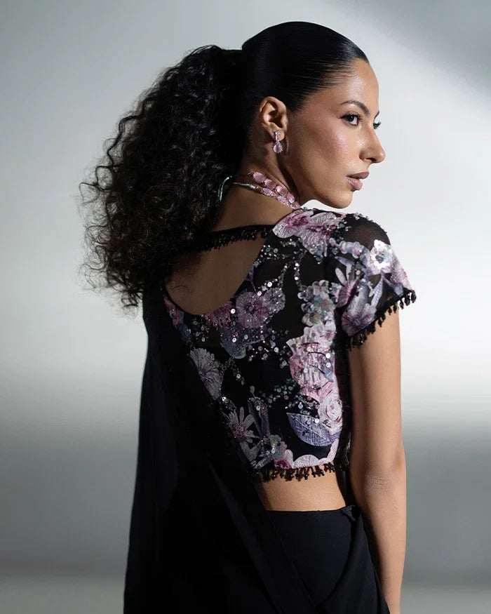 "Focus on the dramatic draped silhouetted ruffles and sleeve finishing of the Vera black ruffle saree set."
