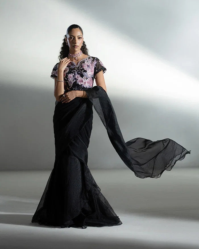 "Detailed view of the layered organza ruffle pallu and applique floral motifs on the Vera black saree."