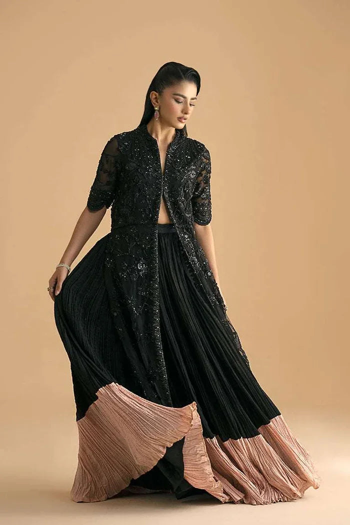 "Detailed view of the structured flared raw silk lehnga featuring heavy hemline border work paired with Vera black front open shirt."