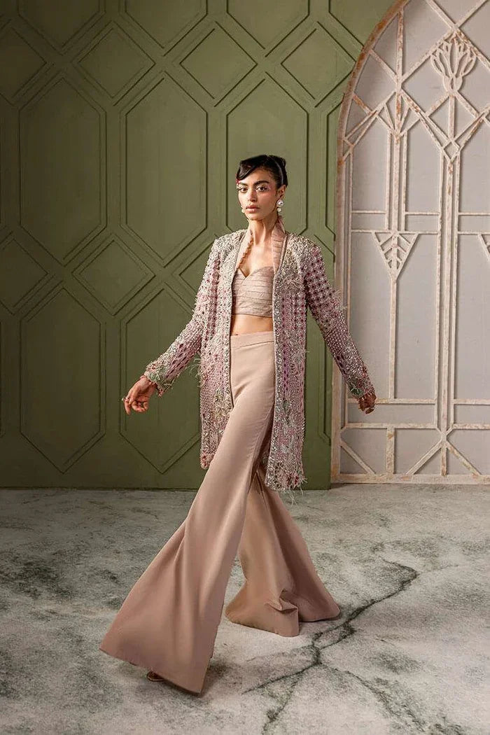 "Detailed view of the tailored flared raw silk trousers paired with the Vera blush pink embellished jacket."