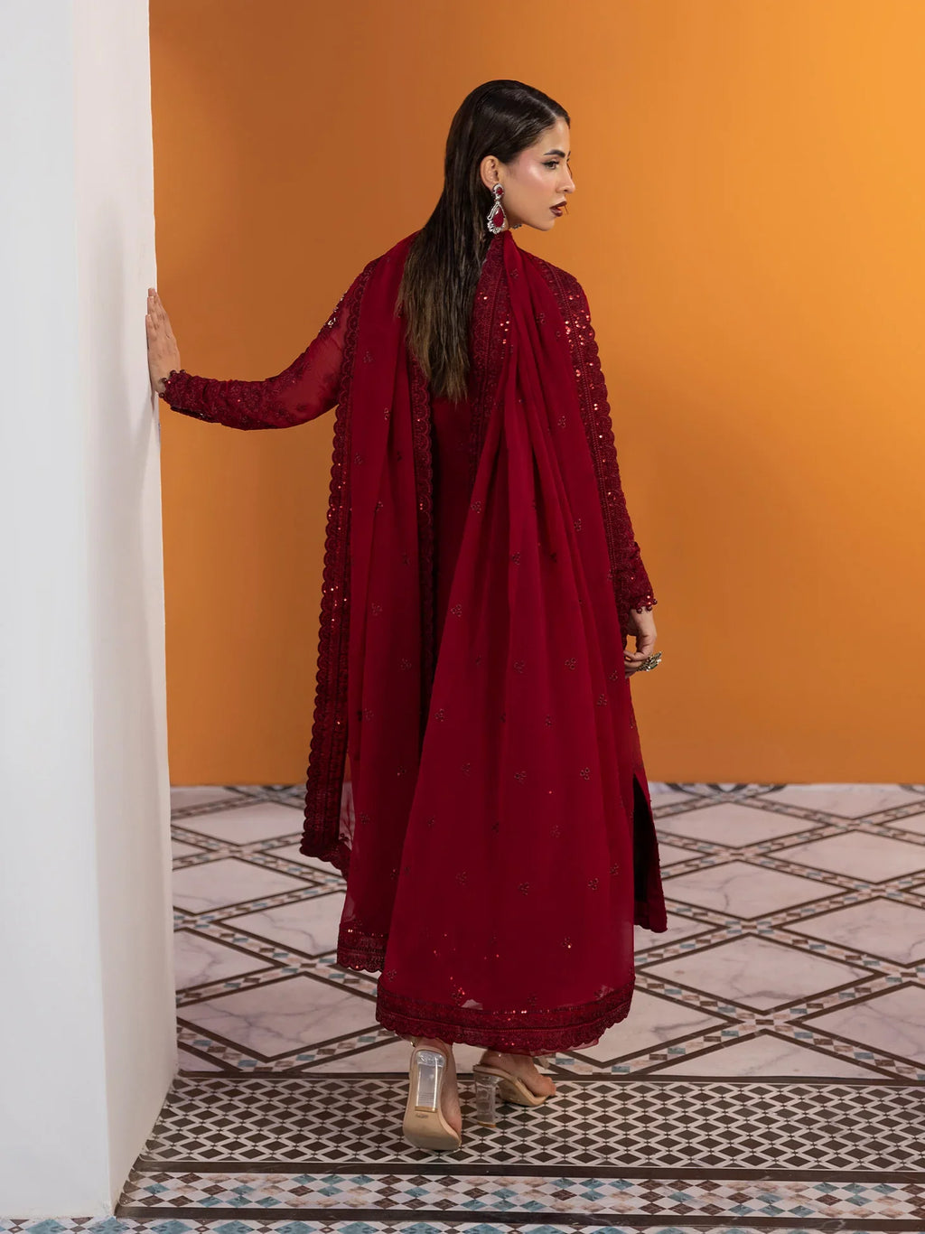 "Detailed drape view of the fluid embroidered statement dupatta paired with the deep red Gulaal Crimson formal suit from Mirha Collections."