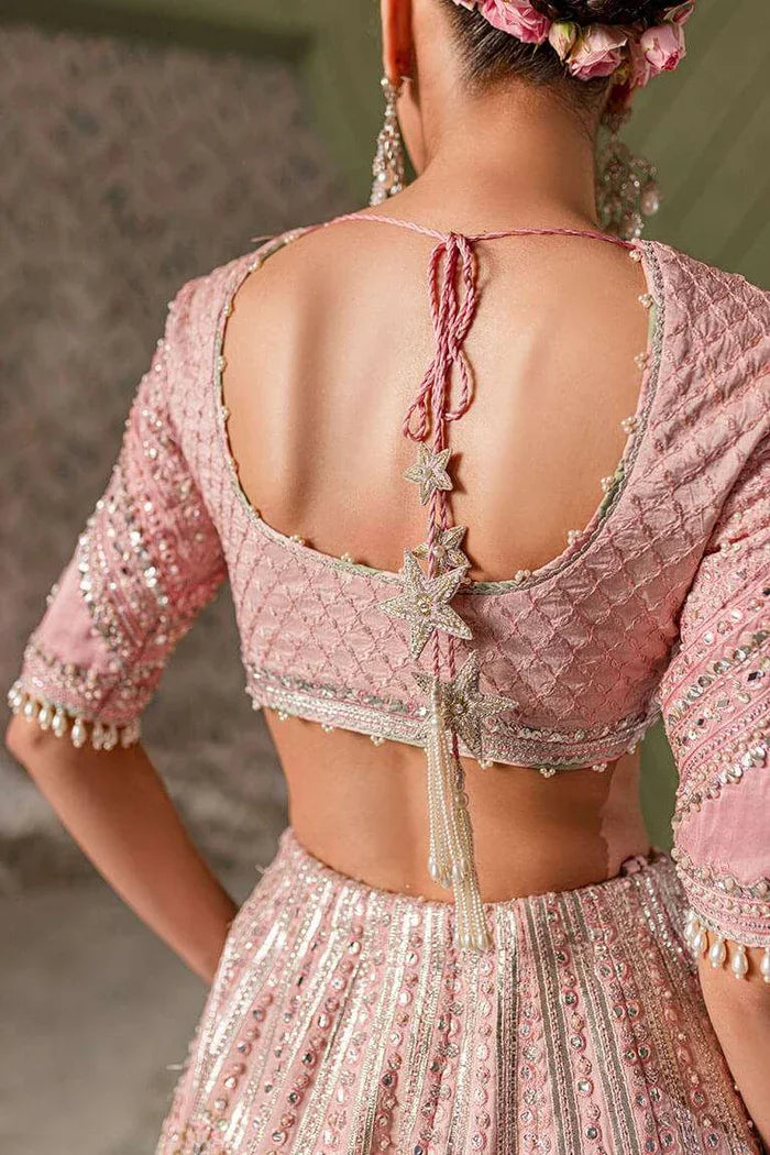 "Detailed view of the structured flared raw silk lehnga featuring silver gota and sequin border work paired with Vera pink choli."