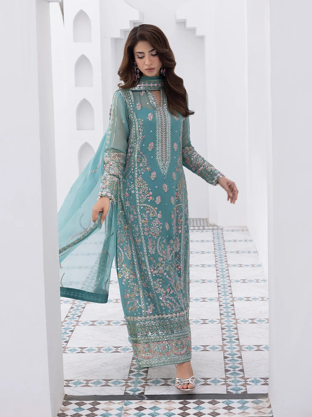 "Focus on the intricate sleeve cuff trimmings and lace hemline details of the Gulaal Desir stitched luxury suit, showing boutique-quality tailoring."