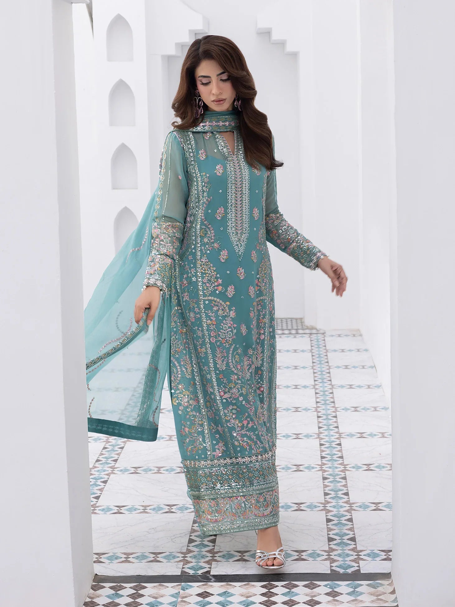 "Focus on the intricate sleeve cuff trimmings and lace hemline details of the Gulaal Desir stitched luxury suit, showing boutique-quality tailoring."