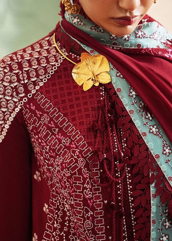 "Close-up of three-panel lawn embroidery, organza neckline patch, and heritage threadwork on Suffuse Ineesa red shirt."