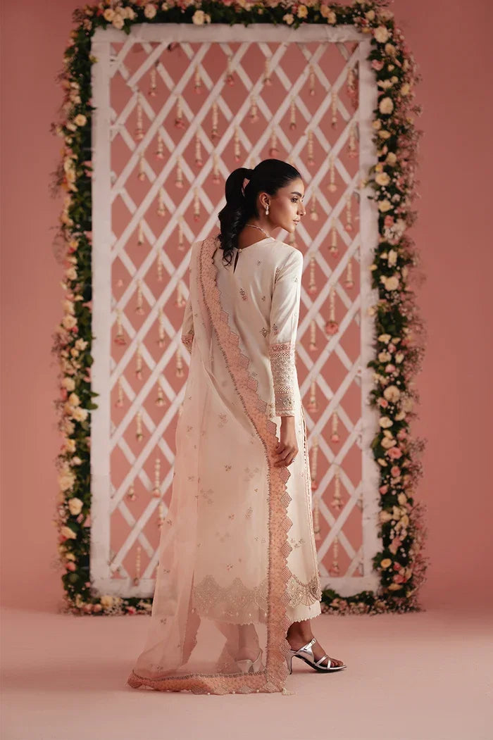 "Scalloped pink organza dupatta styled with ivory embroidered raw silk suit"