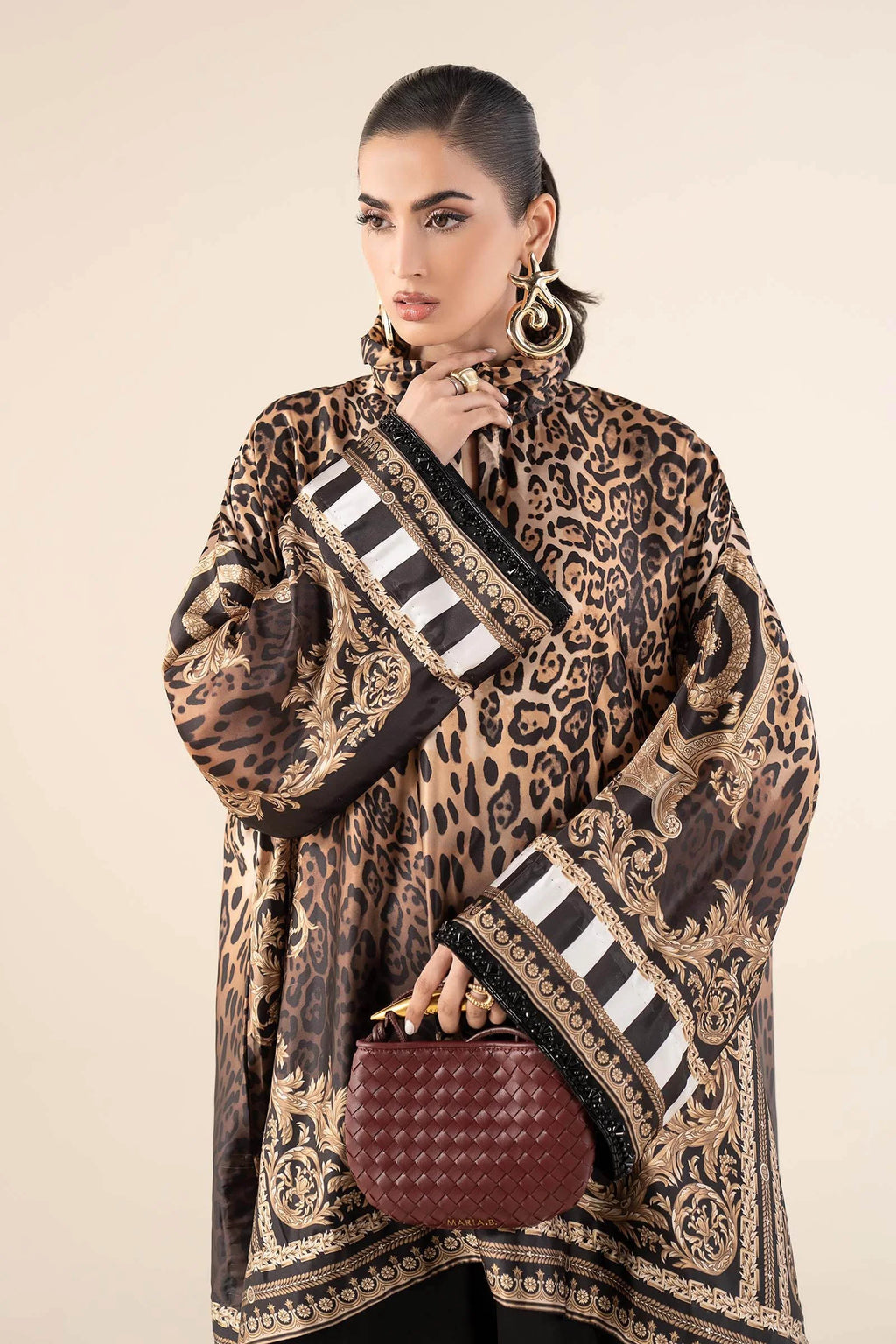 "Focus on the intricate sleeve cuff trimmings and embroidered hemline organza border details of the Maria B MBS-W25-19 Rust stitched luxury suit, showing boutique-quality tailoring."