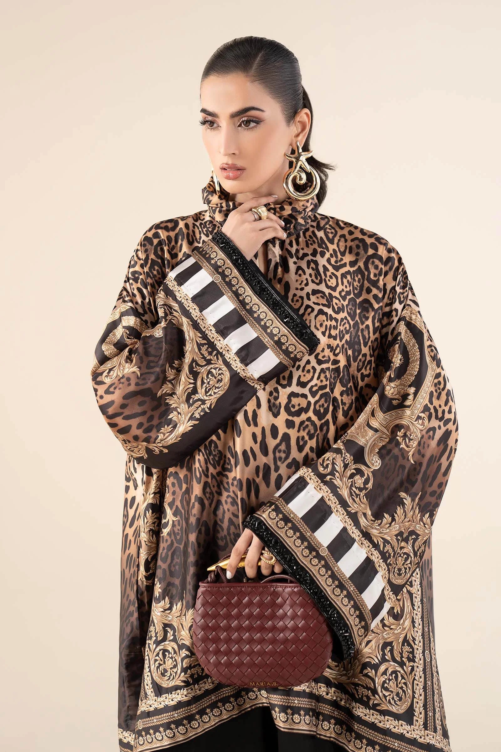 "Focus on the intricate sleeve cuff trimmings and embroidered hemline organza border details of the Maria B MBS-W25-19 Rust stitched luxury suit, showing boutique-quality tailoring."