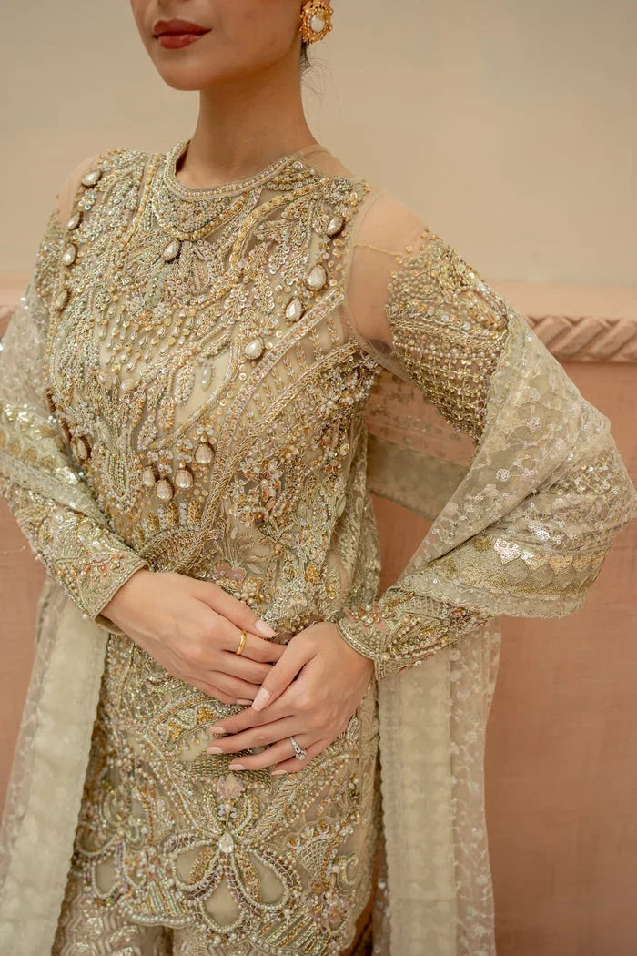 "Close-up of exquisite zardozi embellishments, crystal handwork, and intricate threadwork embroidery on Mysie by Tahira Mantra golden shirt."