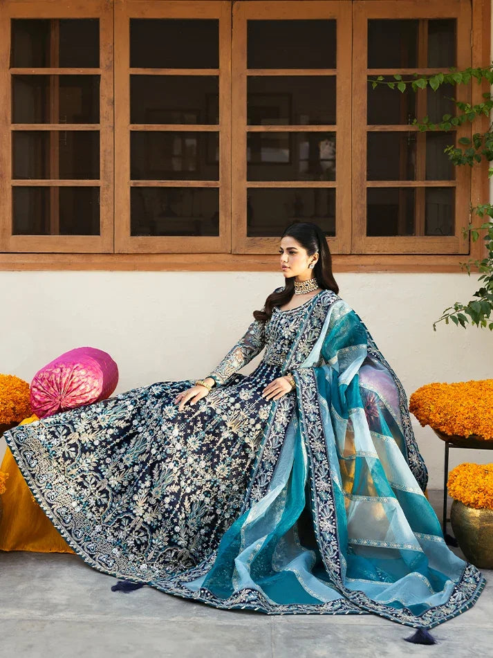"Focus on the intricate sleeve cuff trimmings and cutwork hemline details of the Gulaal Meena stitched luxury suit, showing boutique-quality tailoring."