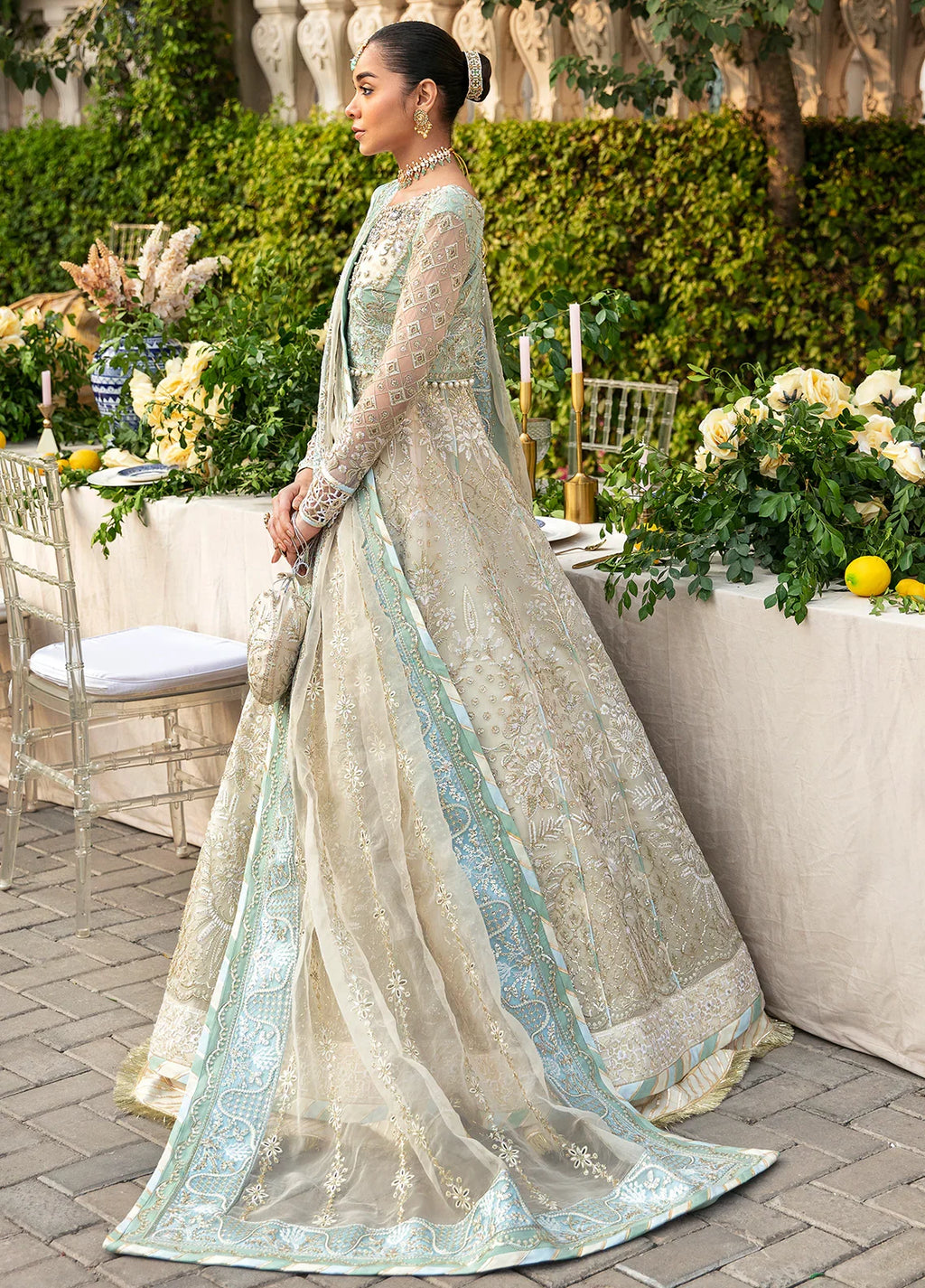"Focus on the intricate sleeve cuff trimmings and embroidered hemline organza border details of the Gulaal Nareena stitched luxury suit, showing boutique-quality tailoring."