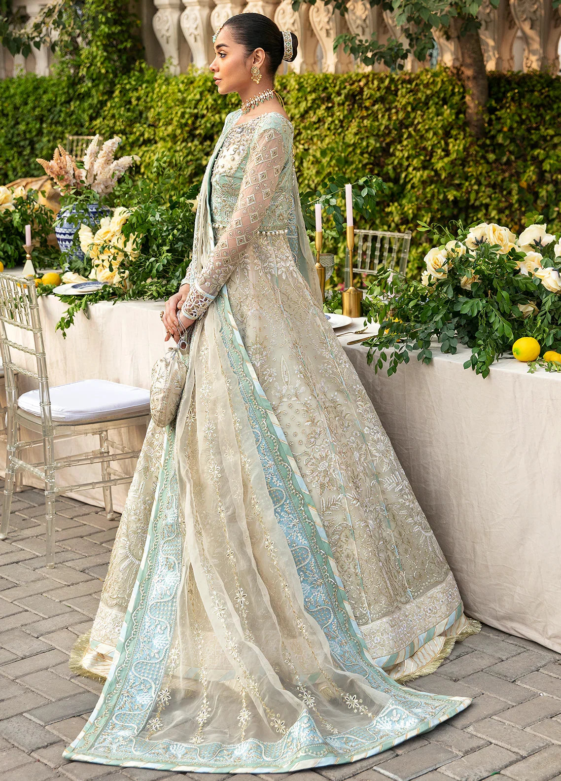 "Focus on the intricate sleeve cuff trimmings and embroidered hemline organza border details of the Gulaal Nareena stitched luxury suit, showing boutique-quality tailoring."