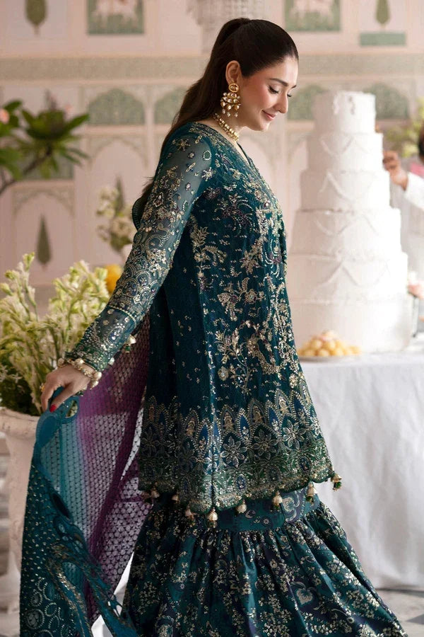"Detailed view of intricate embroidered borders, cutwork daman finishing, and heavy embellishments on Nureh Amania formal suit."
