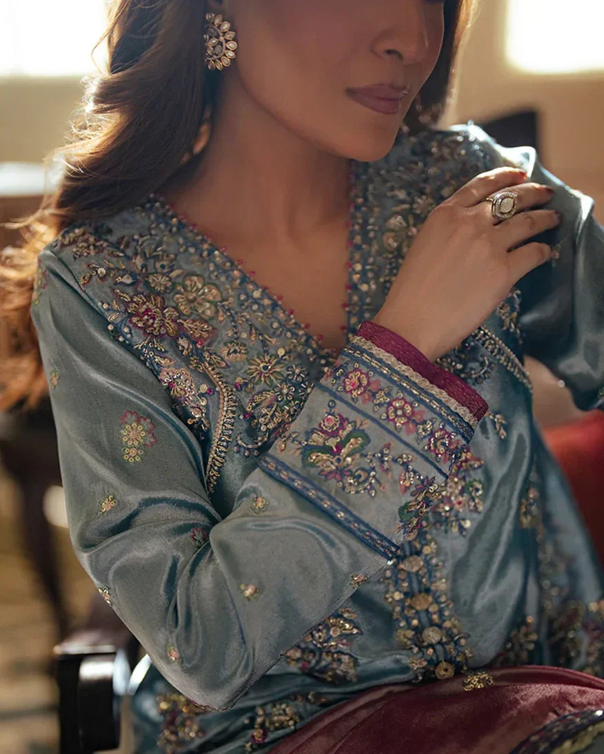 "Close-up detailing on the Mushq Neelam royal blue shirt bodice, displaying fine zari threadwork embroidery, hand-crafted embellishments, and rich satin fabric texture."