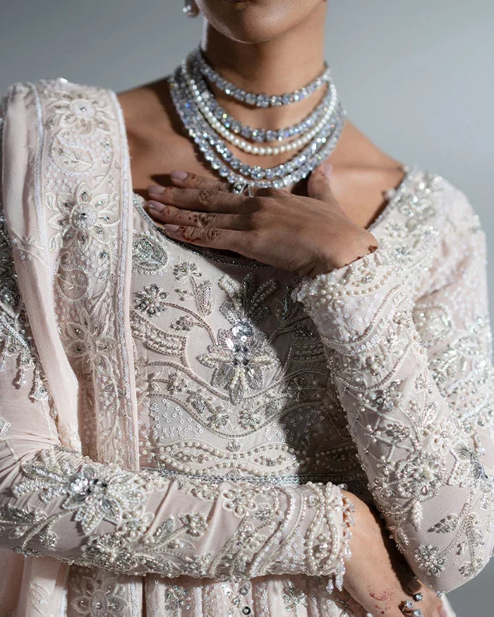 "Close-up detailing on the Vera nude pink kalidaar bodice featuring heavy zardozi embroidery and pearl embellishments."
