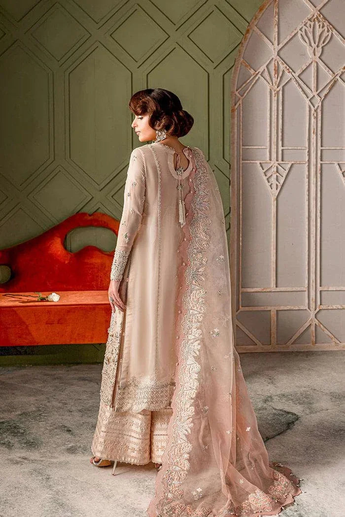 "Detailed view of the wide-leg Azaar trousers featuring intricate embroidered borders in pale peach by Vera."