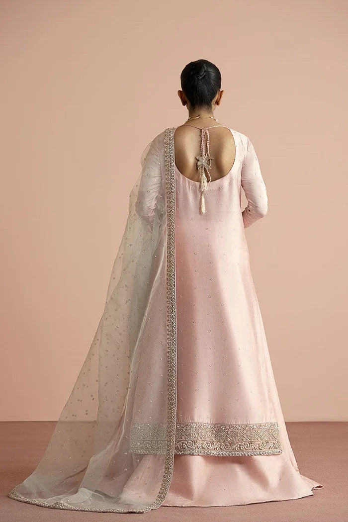 "Detailed view of the structured flared raw silk pink lehnga featuring intricate hemline border work paired with Vera pink shirt."