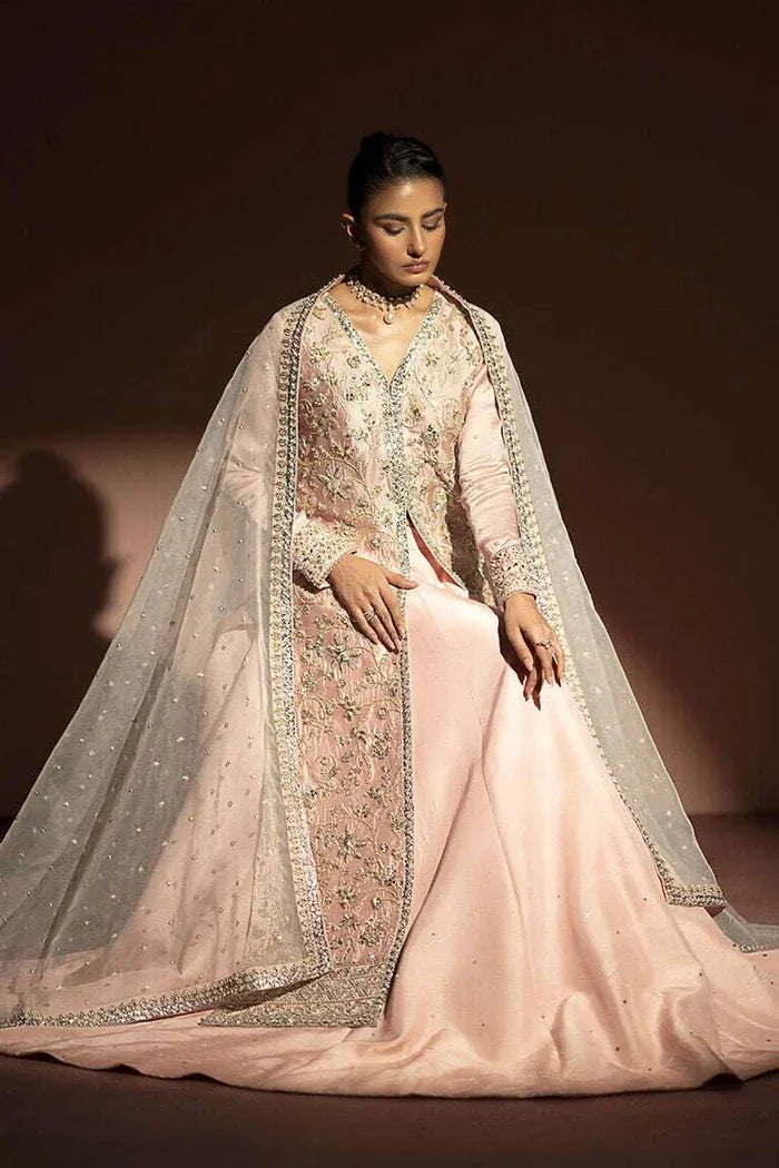 "Focus on the contrasting aqua organza dupatta drape with four-sided embroidered borders paired with Vera pink lehnga set."