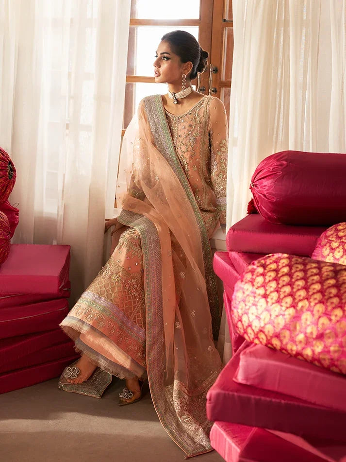 "Focus on the multi-layered raw silk border trimmings and flared sharara hemline details of the Gulaal Raniya stitched luxury suit, showing boutique-quality tailoring."