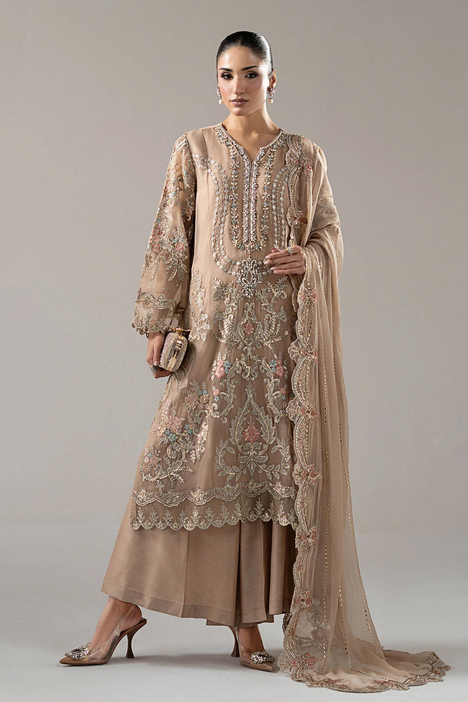 "Mirha Collections Maria B SF-EA25-18R1 skin nude gold 3-piece embroidered chiffon formal suit. Full-length front view featuring tailored shirt, mukaish dupatta, and raw silk Dhaka trousers."