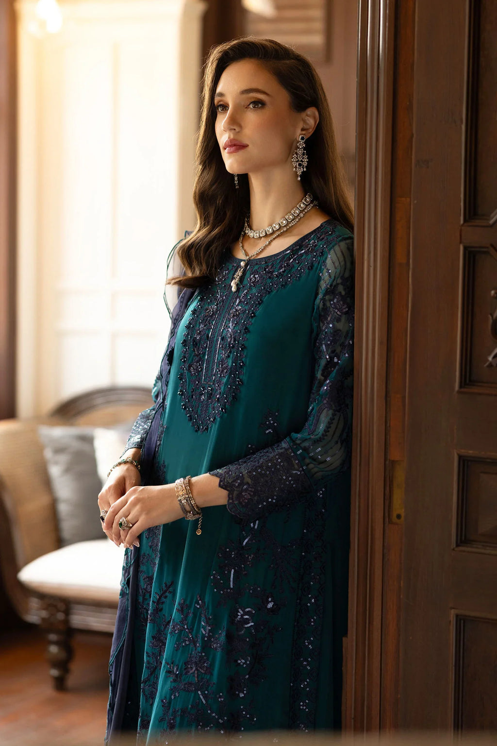 "Focus on matching embellished silk dupatta drape and sleeve border details of the Maria B teal formal outfit."