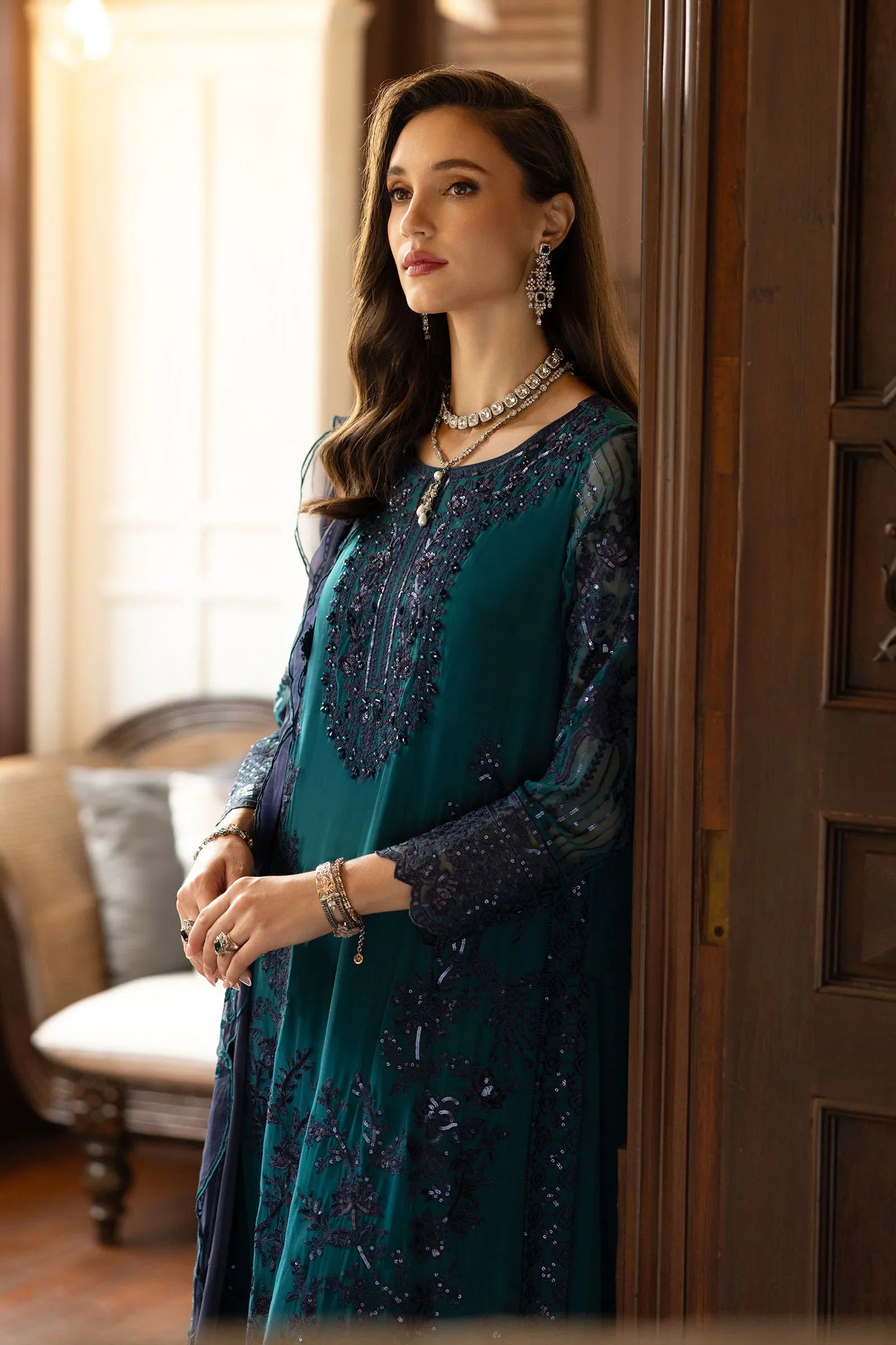 "Focus on matching embellished silk dupatta drape and sleeve border details of the Maria B teal formal outfit."