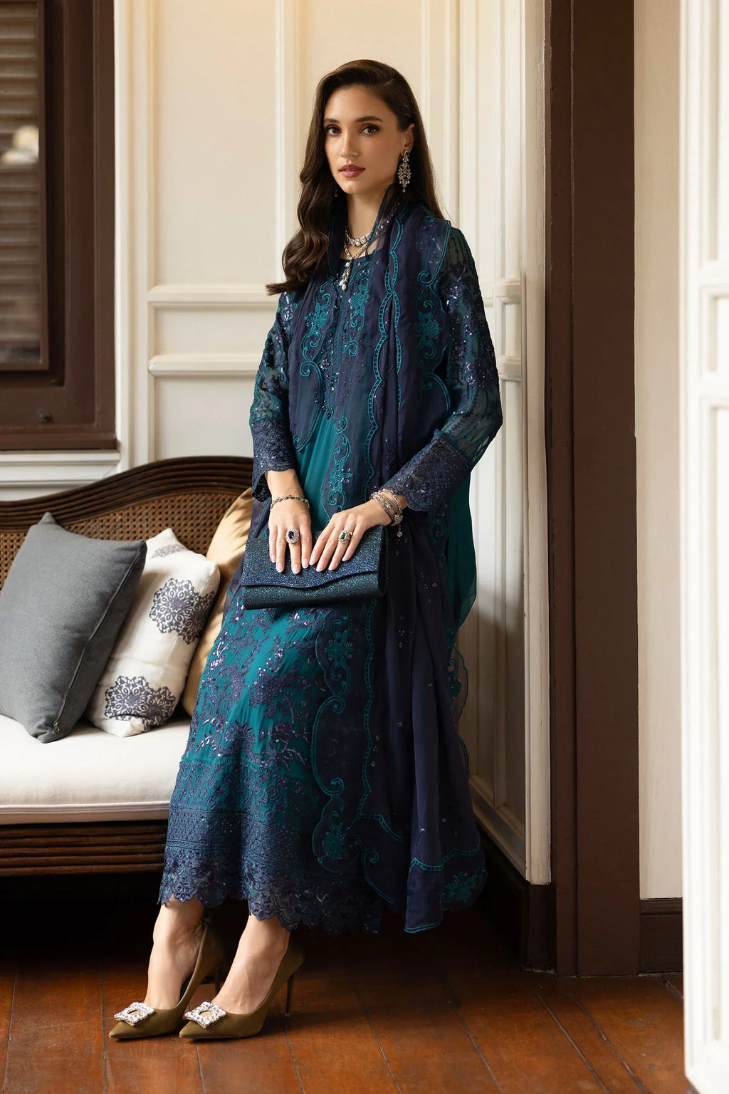"Detailed view of the tailored silk straight trousers paired with embroidered hemline borders on Maria B teal suit."