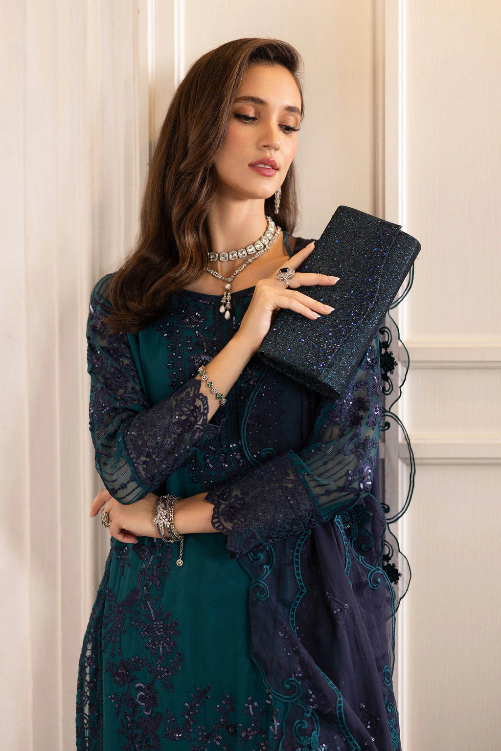 "Close-up of delicate tilla, sequin, and threadwork embroidery on the Maria B teal silk shirt neckline."