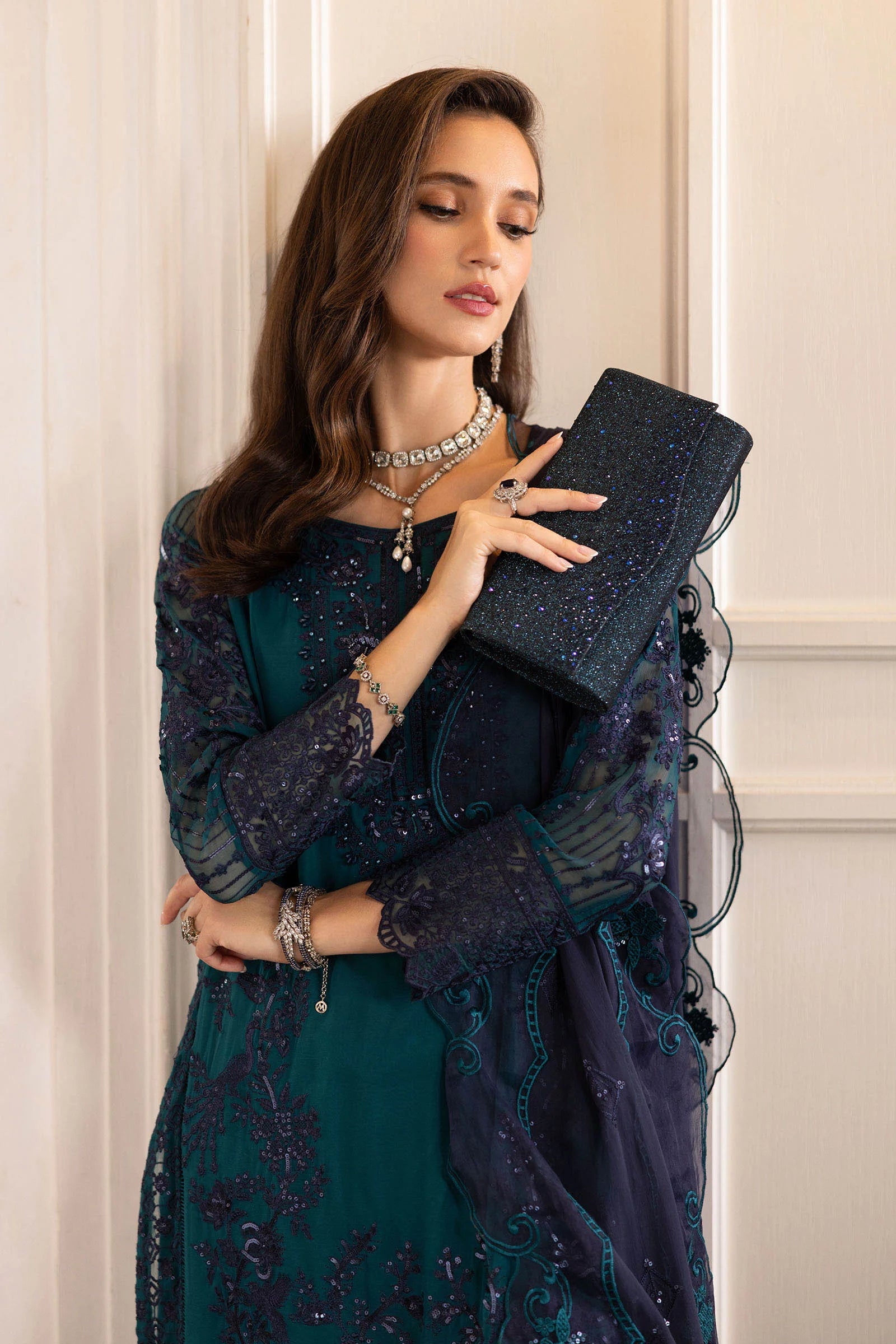 "Close-up of delicate tilla, sequin, and threadwork embroidery on the Maria B teal silk shirt neckline."