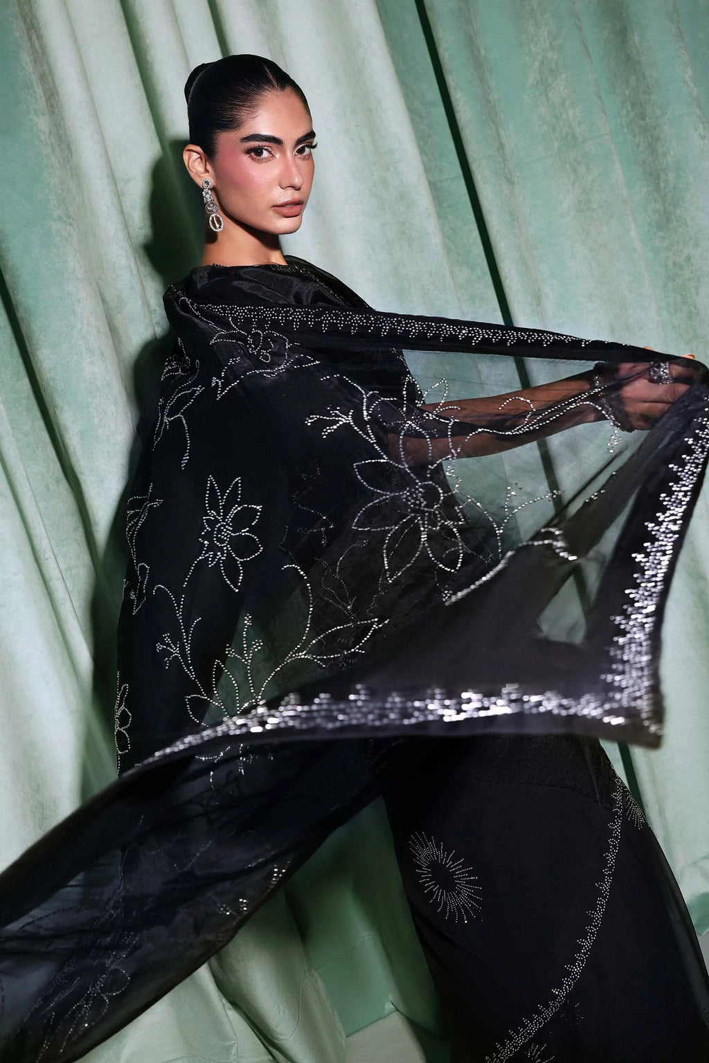 "Detailed drape view of the fluid black chiffon saree pallu with all-over diamante embellishments from the Maria B SF-PF26-02 collection at Mirha Collections."