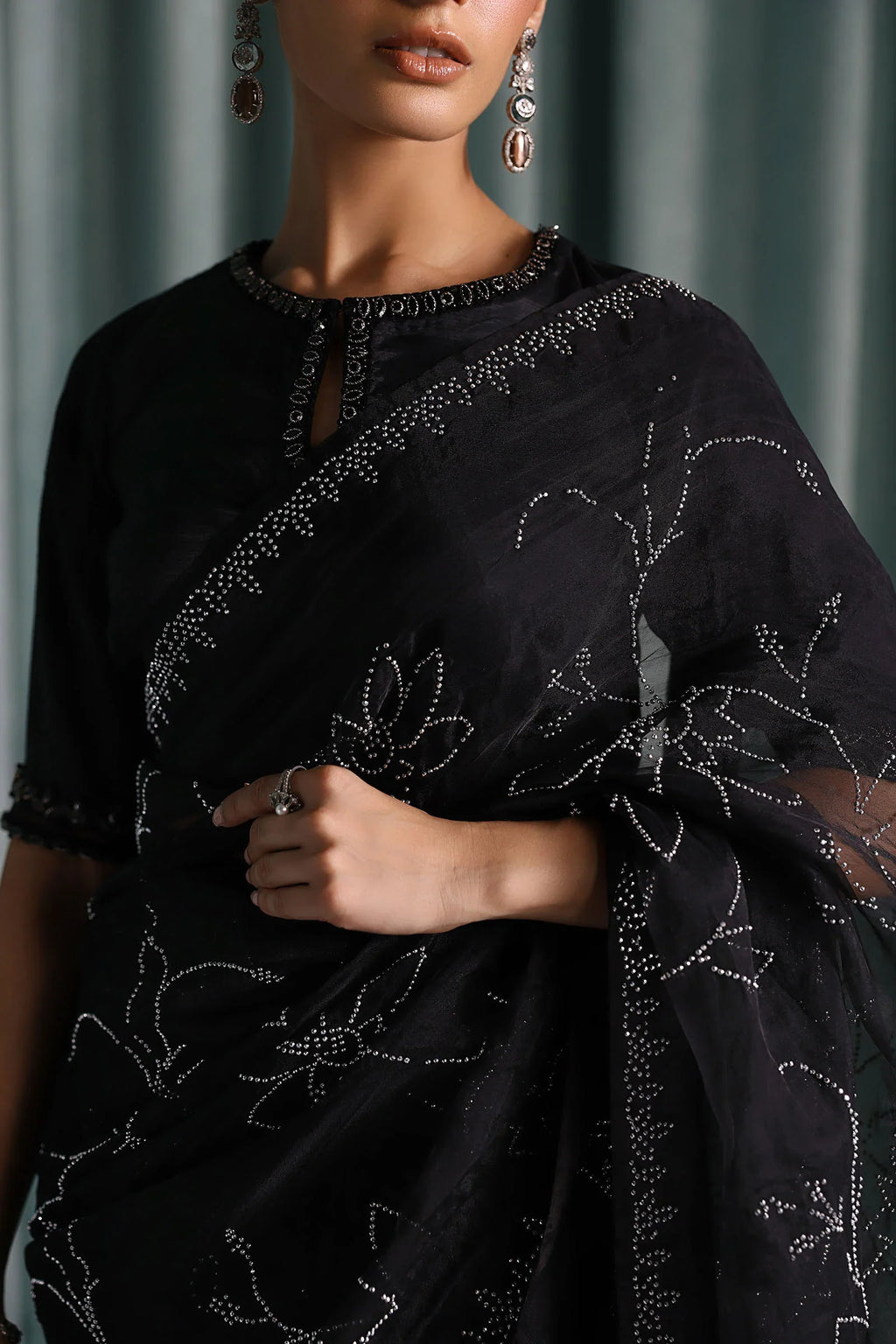 "Close-up detailing on the Maria B SF-PF26-02 Black raw silk blouse, displaying hand-worked adda neckline embellishments, sparkling sequin accents, and fine fabric texture."