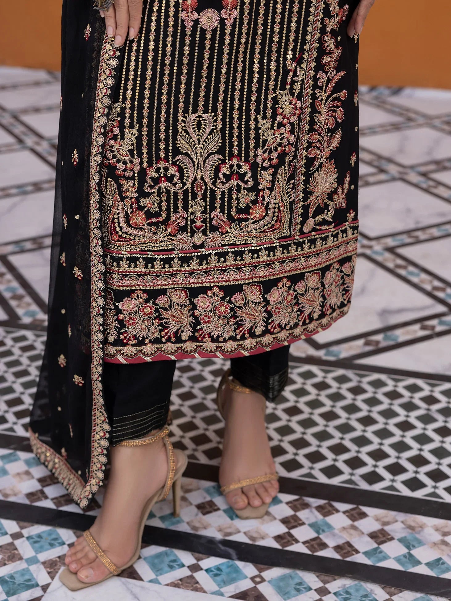 "Focus on the intricate sleeve cuff trimmings and lace hemline details of the Gulaal Soir stitched luxury suit, showing boutique-quality tailoring."
