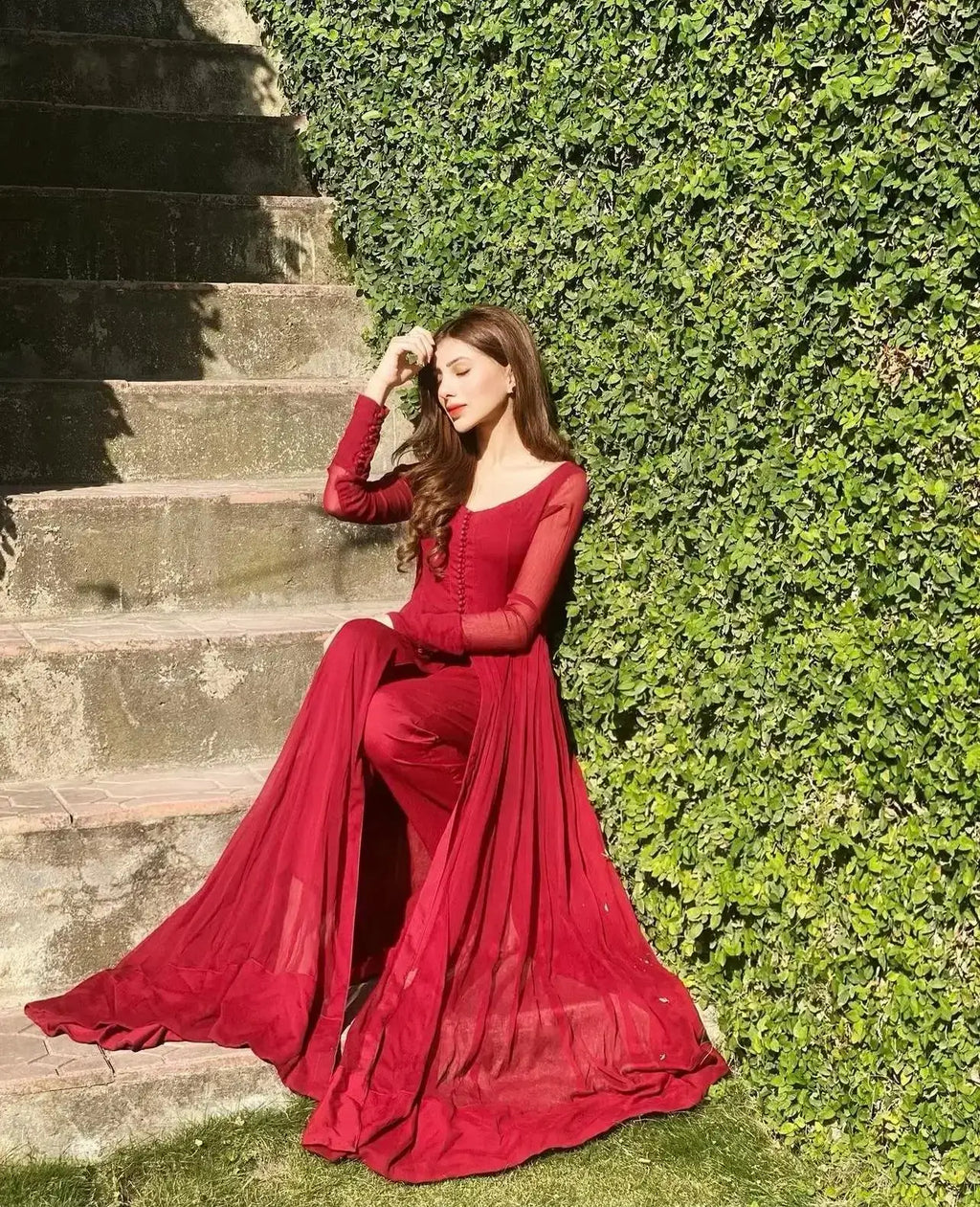 "Focus on the wide flared hemline border and sleeve details of the LXM Regal Red stitched chiffon Kalidaar frock, showing boutique-quality tailoring."