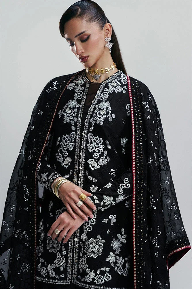 "Detailed view of cuff borders and embroidered hemline trims on the Suffuse Zaarish silk pret outfit."