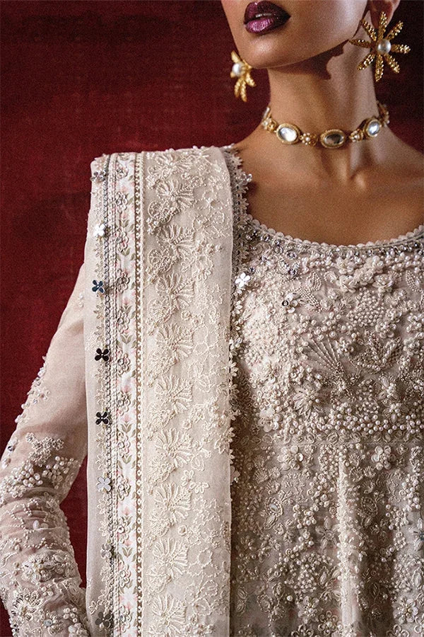 "Close-up of hand-worked zardozi, perl accents, shimmering sequin highlights, and fine resham embroidery on Suffuse Zahrell ivory bodice."