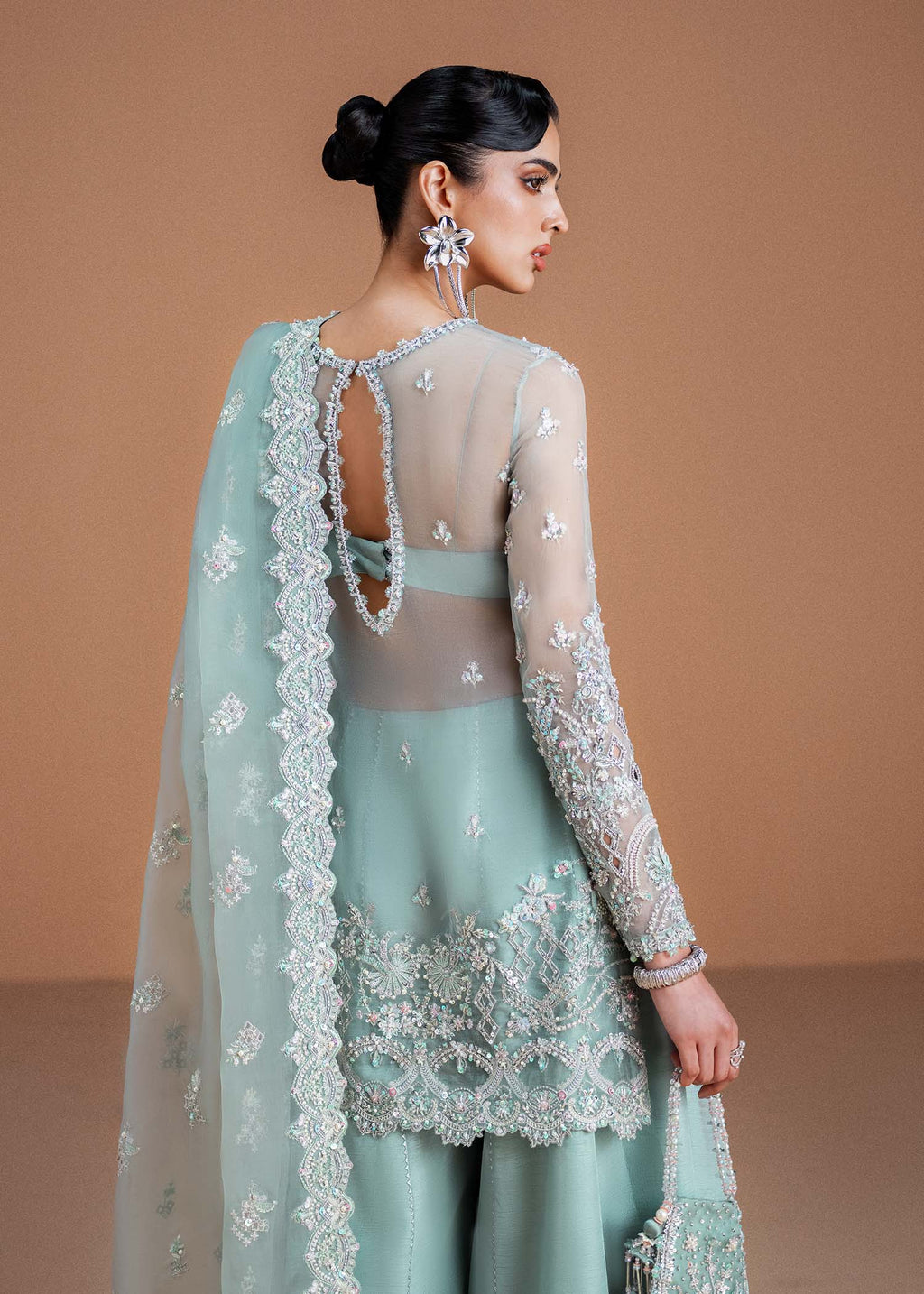 "Rear profile view of the Kanwal Malik Vania shirt, showcasing the clean contemporary tailoring and the chic, elegant keyhole design element crafted on the back upper bodice."