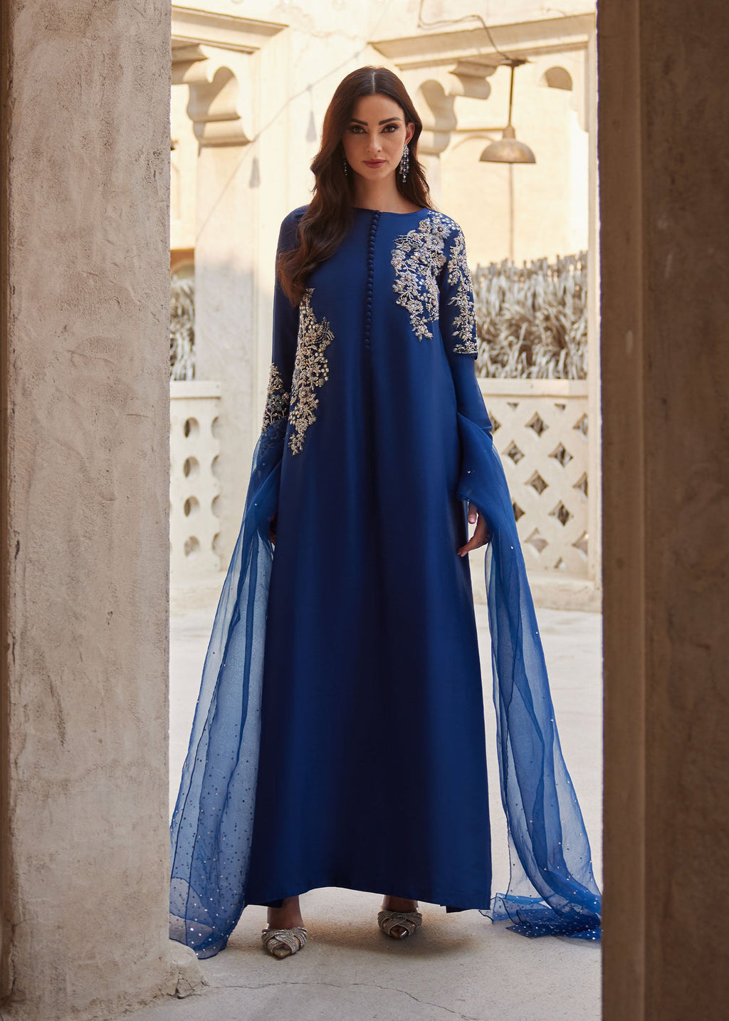 "Mirha Collections Kanwal Malik Huda luxury three-piece Pakistani designer suit. Full-length presentation showcasing a sophisticated navy blue pure raw silk long straight shirt with matching straight trousers and a deep navy organza dupatta."