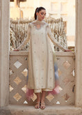 "Mirha Collections Kanwal Malik Reham luxury three-piece Pakistani designer suit. Full-length view showcasing an elegant ivory off-white pure raw silk straight shirt with a heavily embroidered neckline, paired with tailored straight trousers and a gradient-dyed organza dupatta."