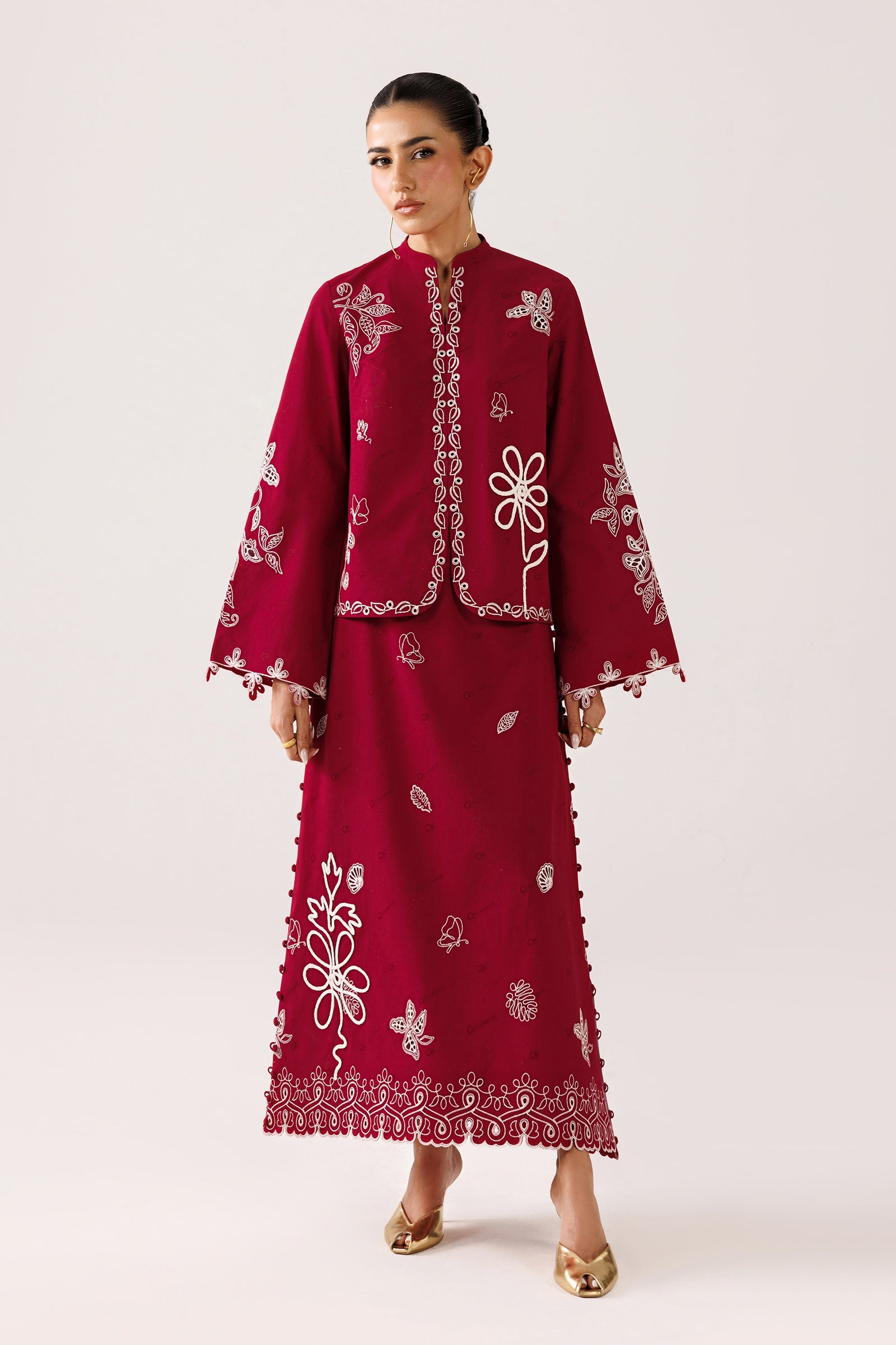 "Mirha Collections Qalamkar QEC-10 Reina luxury embroidered stitched suit. Crimson self-jacquard silhouette featuring bold ivory embroidery and tailored skirt/trousers."