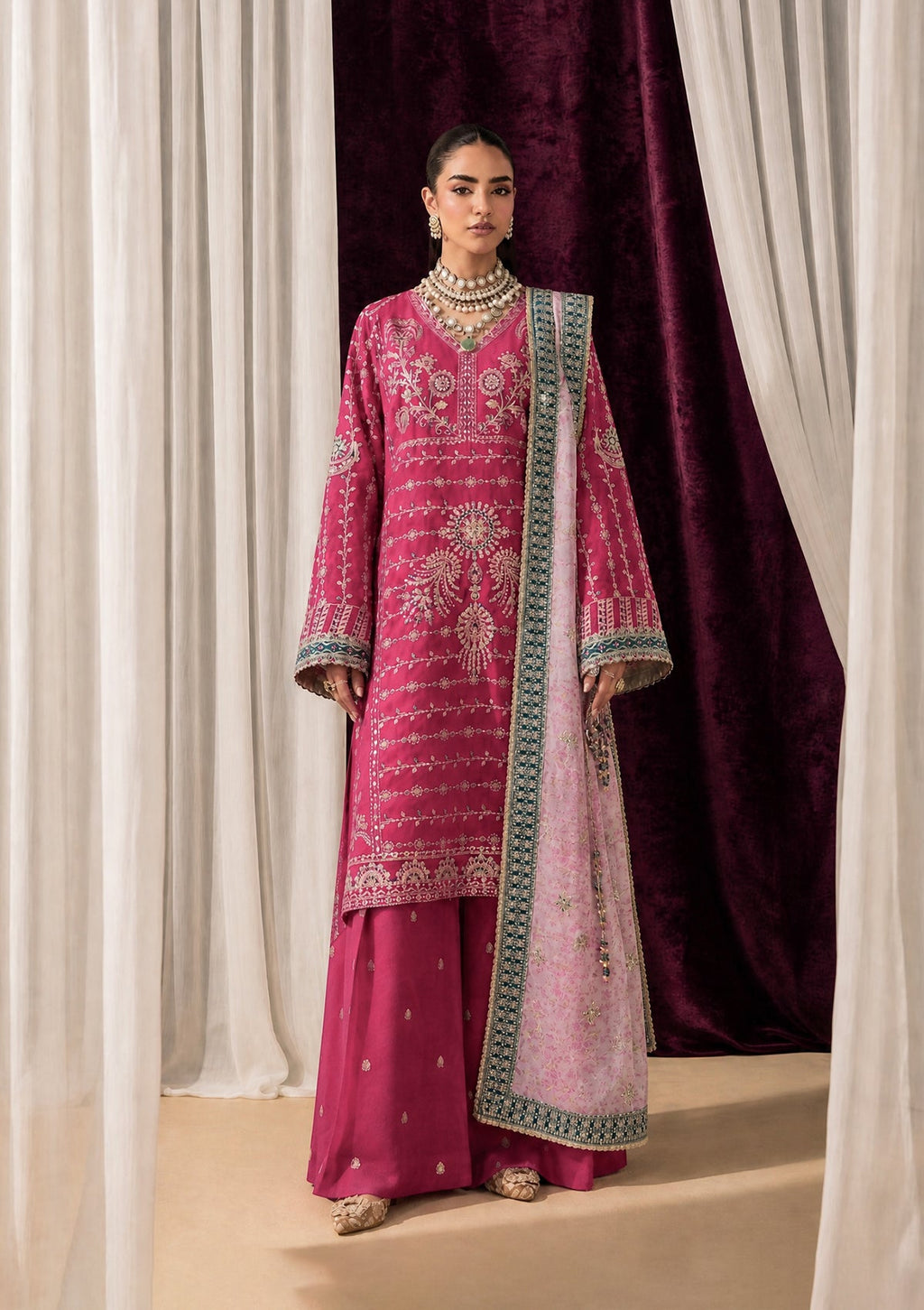 "Mirha Collections Aik Shaam Look B2606 three-piece Pakistani designer suit. Full-length presentation featuring a heavily embroidered dark evening formal shirt paired with tailored silk trousers and an embellished luxury dupatta."
