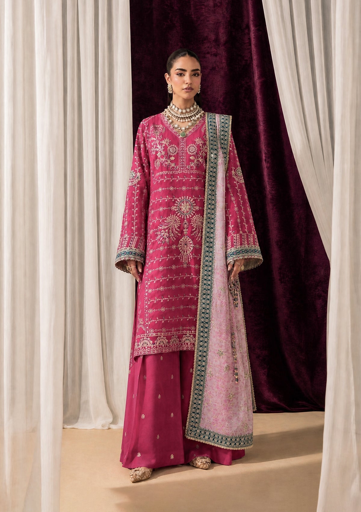 "Mirha Collections Aik Shaam Look B2606 three-piece Pakistani designer suit. Full-length presentation featuring a heavily embroidered dark evening formal shirt paired with tailored silk trousers and an embellished luxury dupatta."