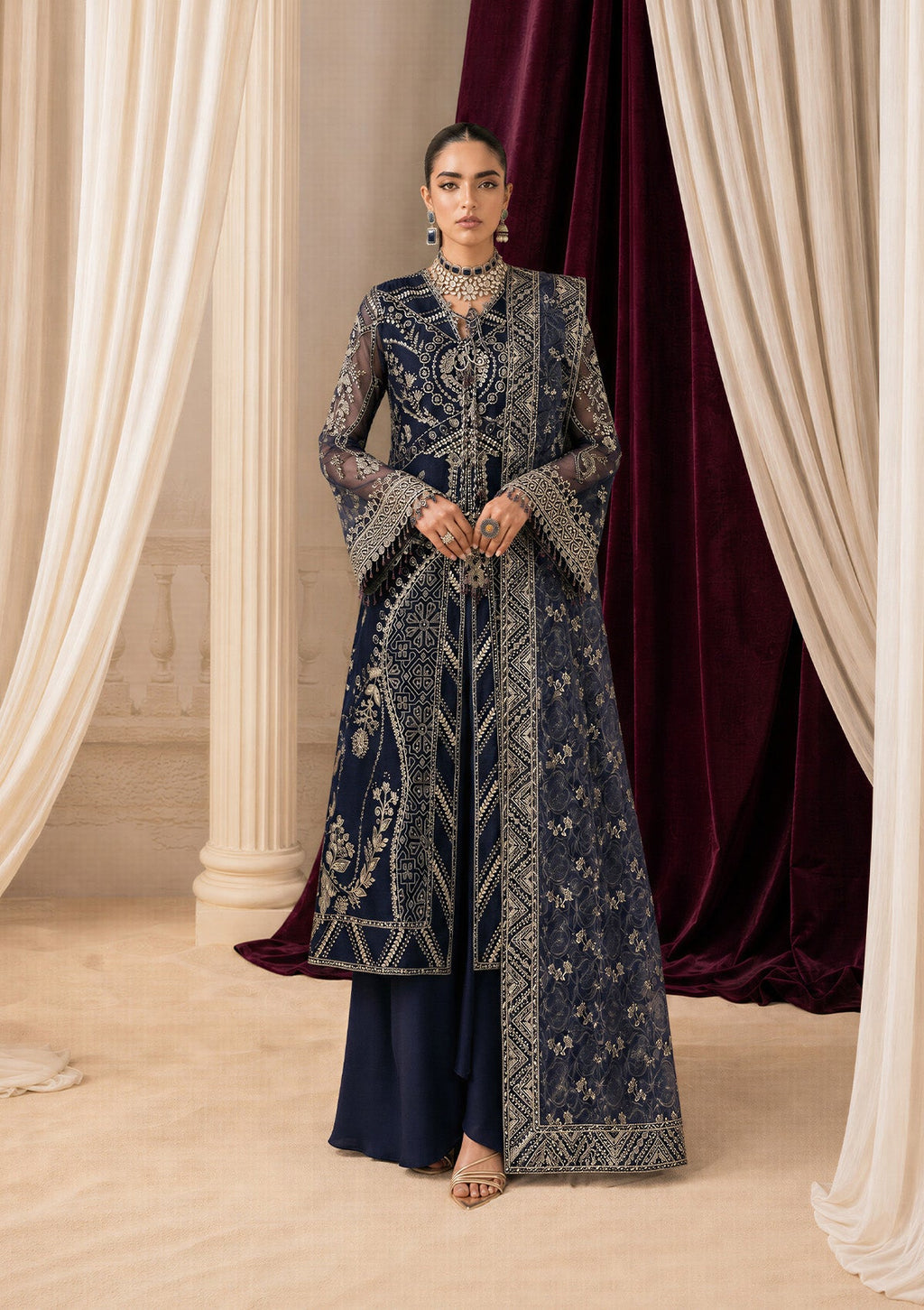 "Mirha Collections Aik Shaam Look B2604 three-piece Pakistani designer suit. Full-length presentation featuring a heavily embroidered dark evening formal shirt paired with tailored silk trousers and an embellished luxury dupatta."