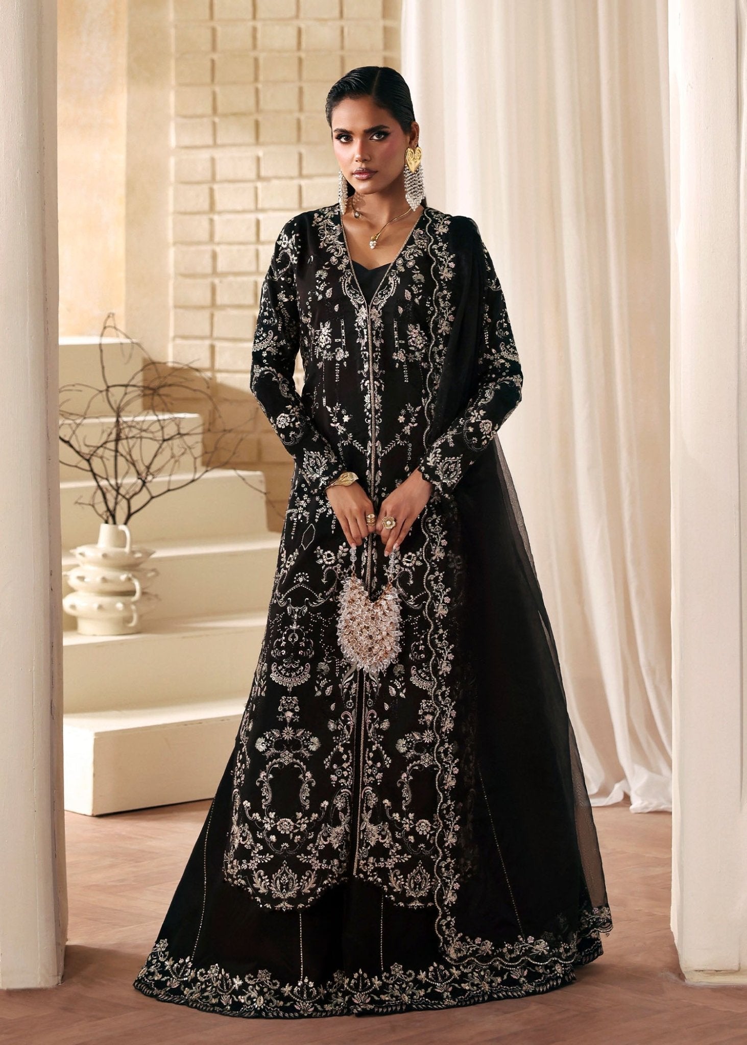 "Mirha Collections Kanwal Malik Mahsa luxury three-piece Pakistani designer suit. Full-length view highlighting a striking deep bottle green pure raw silk straight shirt paired with matching tailored trousers and a premium coordinated organza dupatta."
