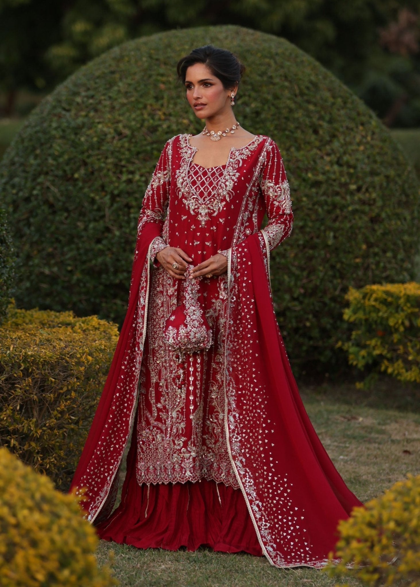 "Mirha Collections Kanwal Malik Aden luxury three-piece Pakistani designer formal suit. Full-length presentation showcasing a striking deep magenta pink embroidered straight shirt beautifully paired with a matching flared gharara pants layout and a luxury dupatta."