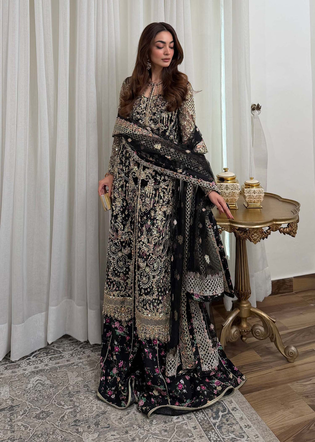"Detailed shot of the luxury plum organza dupatta from the Kanwal Malik Rina collection, emphasizing the ethereal fluid drape and its premium dense-to-light gradient sequin spray finish."