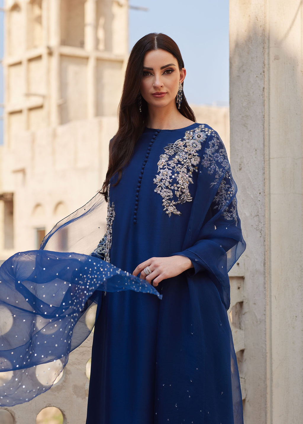 "Close-up premium detailing on the Kanwal Malik Huda navy shirt, highlighting the stunning asymmetrical layout of intricate traditional Ada handwork, delicate hand-crafted embellishments, and artisanal motifs."