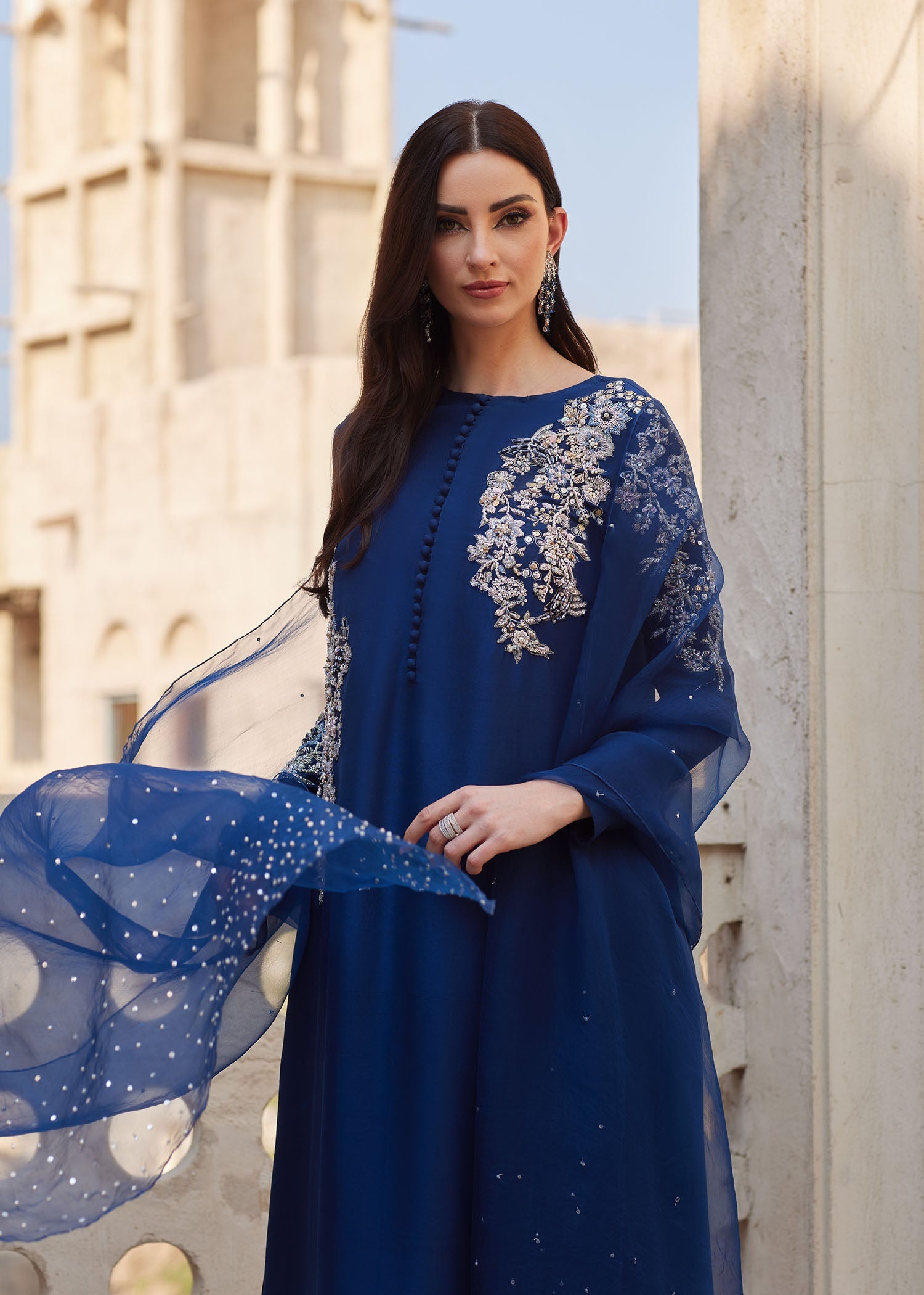 "Close-up premium detailing on the Kanwal Malik Huda navy shirt, highlighting the stunning asymmetrical layout of intricate traditional Ada handwork, delicate hand-crafted embellishments, and artisanal motifs."
