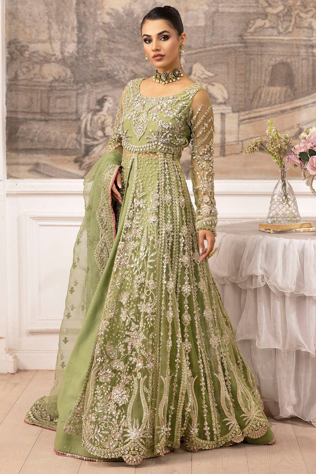 "Close-up detailing on the Motifz Iyara silk net fabric, highlighting fine threadwork embroidery, subtle tilla accents, and delicate sequin detailing along the neckline patch."