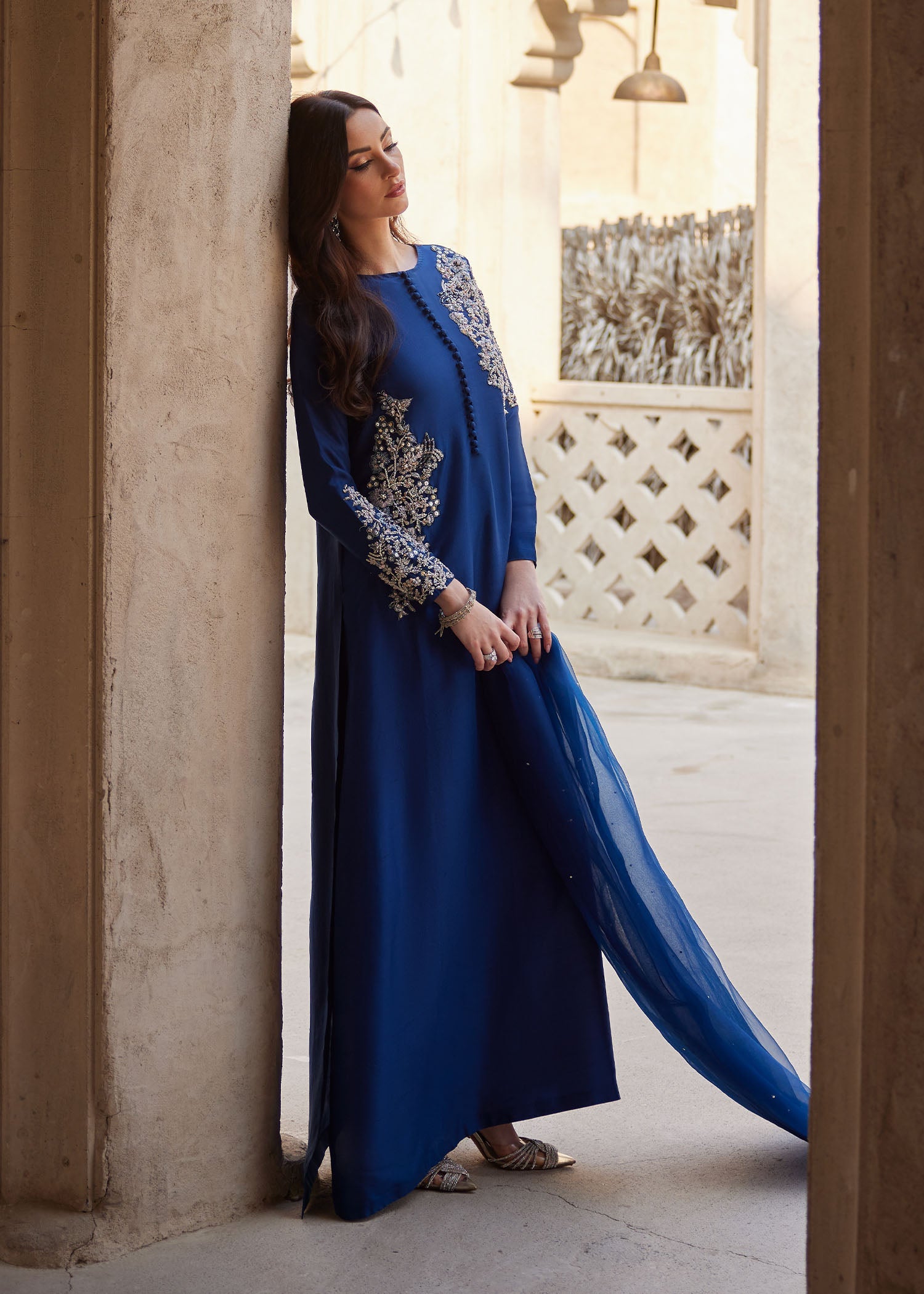 "Detailed shot of the luxury navy blue medium organza dupatta from the Kanwal Malik Huda collection, emphasizing the ethereal fluid drape and its premium dense-to-light gradient sequin spray finish."